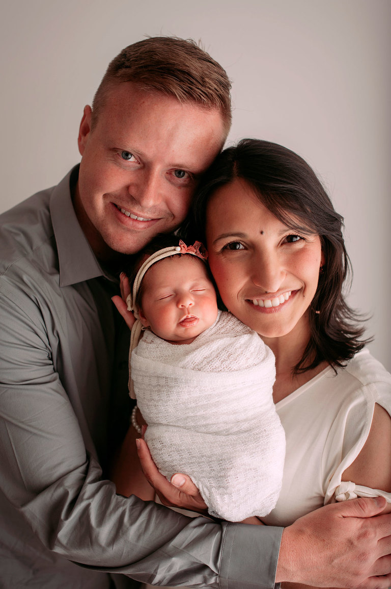 Newborn girl photography posing with mom and dad